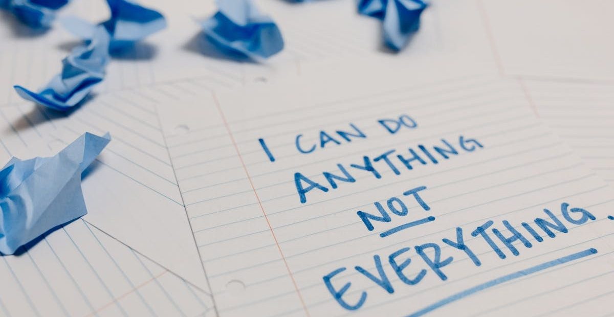 Handwritten motivational quote on lined paper with crumpled notes around, emphasizing self-empowerment.