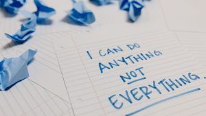 Handwritten motivational quote on lined paper with crumpled notes around, emphasizing self-empowerment.
